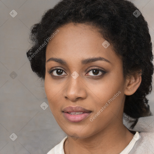 Joyful black young-adult female with short  black hair and brown eyes