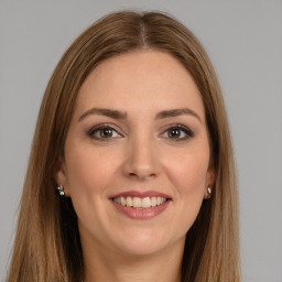 Joyful white young-adult female with long  brown hair and brown eyes