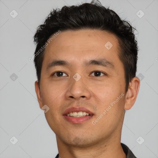 Joyful asian young-adult male with short  black hair and brown eyes