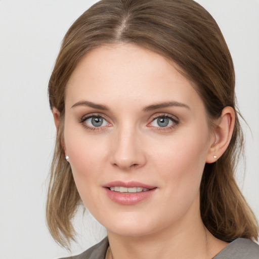 Joyful white young-adult female with medium  brown hair and blue eyes