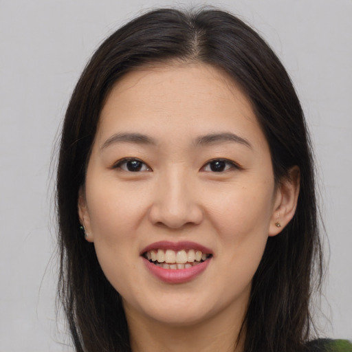 Joyful asian young-adult female with medium  brown hair and brown eyes