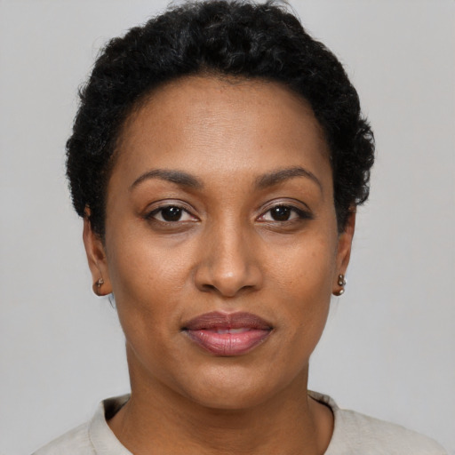 Joyful black adult female with short  black hair and brown eyes