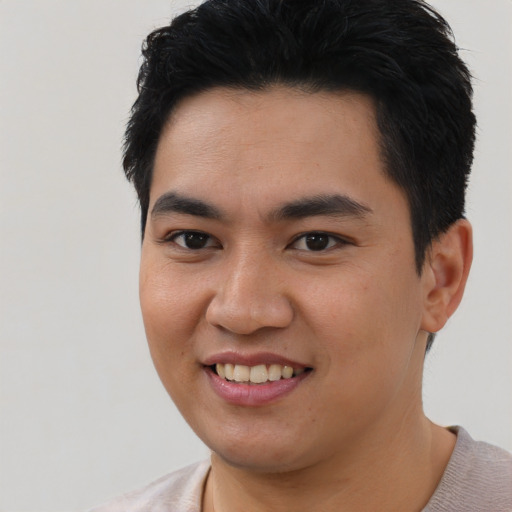 Joyful latino young-adult male with short  black hair and brown eyes