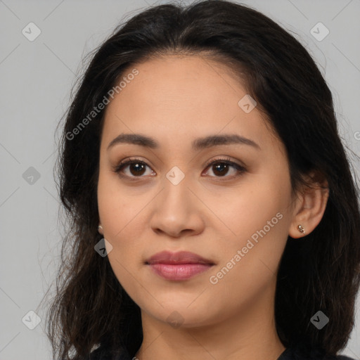 Joyful latino young-adult female with long  brown hair and brown eyes