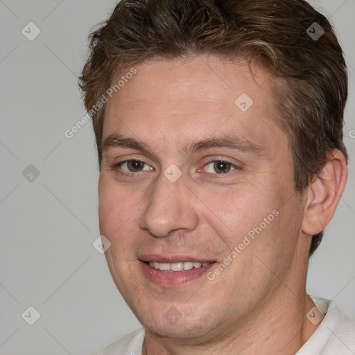 Joyful white adult male with short  brown hair and brown eyes