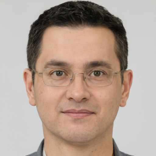 Joyful white adult male with short  brown hair and brown eyes
