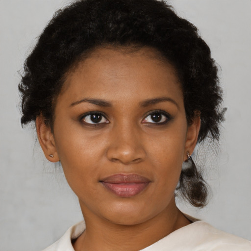 Joyful black young-adult female with short  brown hair and brown eyes