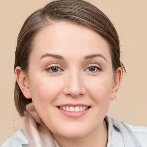 Joyful white young-adult female with medium  brown hair and blue eyes