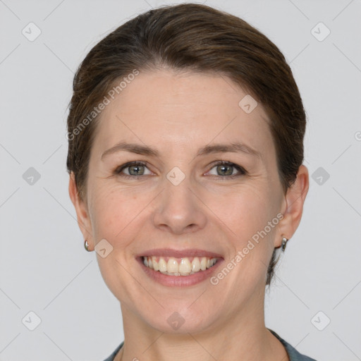 Joyful white adult female with short  brown hair and grey eyes