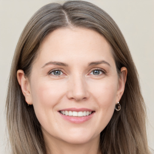 Joyful white young-adult female with long  brown hair and grey eyes