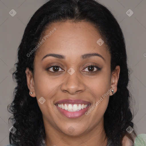 Joyful black young-adult female with long  brown hair and brown eyes