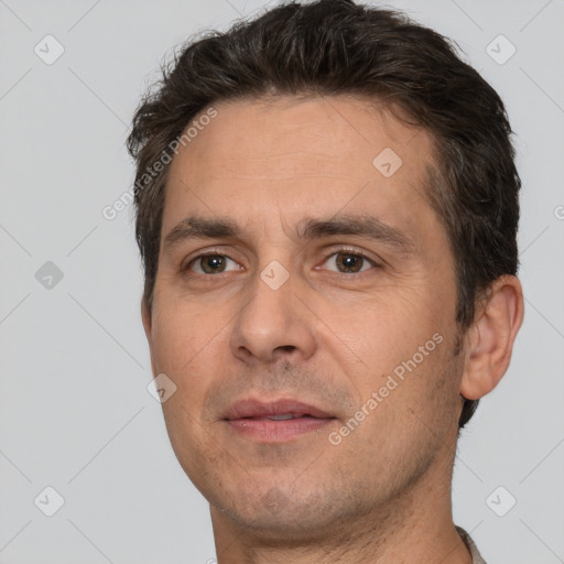 Joyful white adult male with short  brown hair and brown eyes