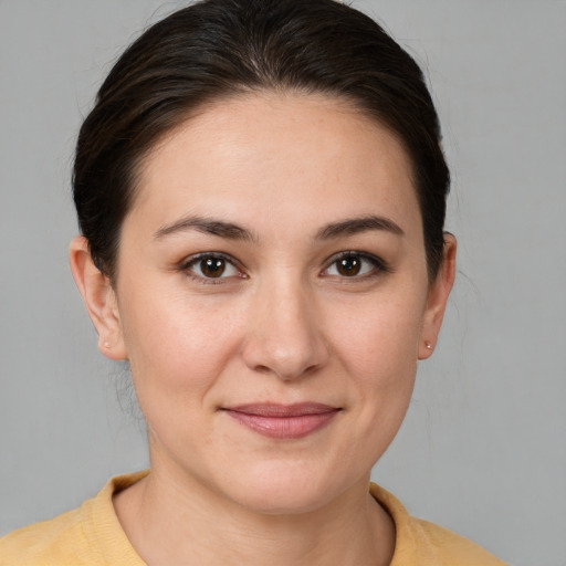 Joyful white young-adult female with medium  brown hair and brown eyes