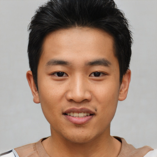 Joyful asian young-adult male with short  black hair and brown eyes