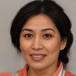 Joyful white adult female with medium  brown hair and brown eyes