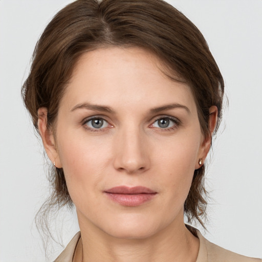 Joyful white young-adult female with medium  brown hair and grey eyes