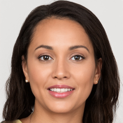 Joyful white young-adult female with long  brown hair and brown eyes