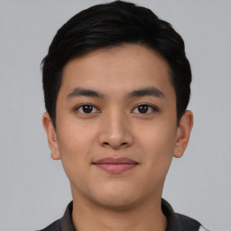 Joyful asian young-adult male with short  black hair and brown eyes