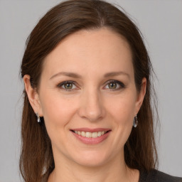 Joyful white young-adult female with long  brown hair and grey eyes