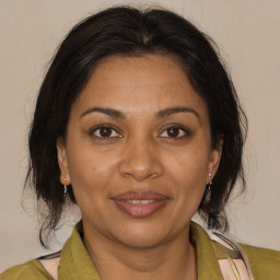 Joyful black adult female with medium  brown hair and brown eyes