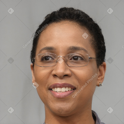 Joyful black adult female with short  brown hair and brown eyes