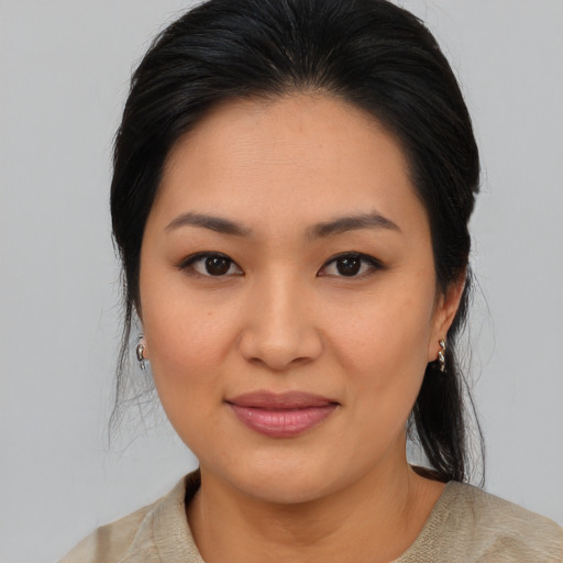 Joyful asian young-adult female with medium  black hair and brown eyes