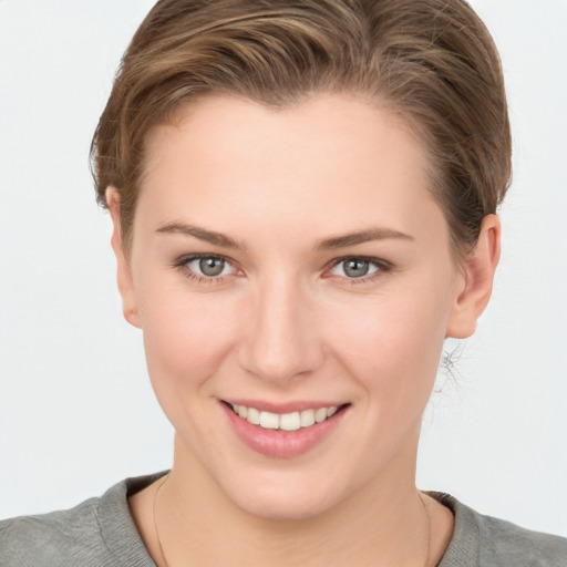 Joyful white young-adult female with short  brown hair and grey eyes