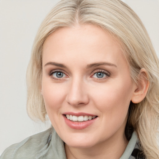 Joyful white young-adult female with long  brown hair and blue eyes