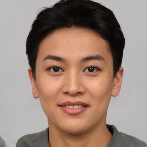 Joyful asian young-adult female with short  black hair and brown eyes