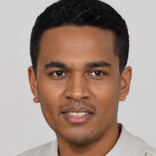 Joyful latino young-adult male with short  black hair and brown eyes