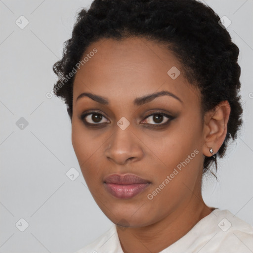 Joyful black young-adult female with short  black hair and brown eyes