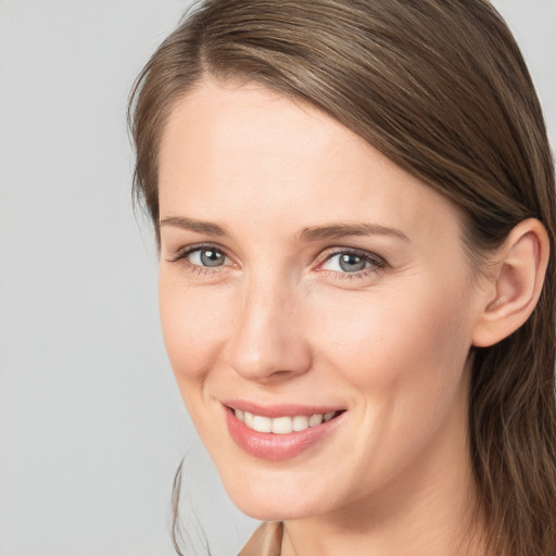 Joyful white young-adult female with long  brown hair and brown eyes