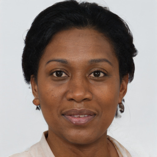 Joyful black adult female with short  brown hair and brown eyes