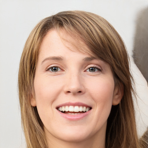 Joyful white young-adult female with long  brown hair and grey eyes