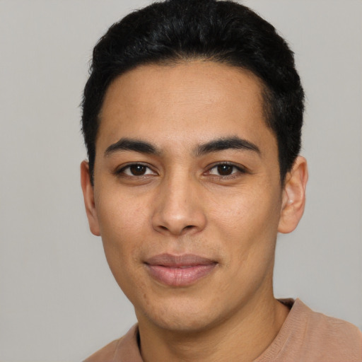 Joyful latino young-adult male with short  black hair and brown eyes