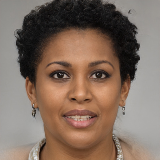 Joyful black young-adult female with short  brown hair and brown eyes