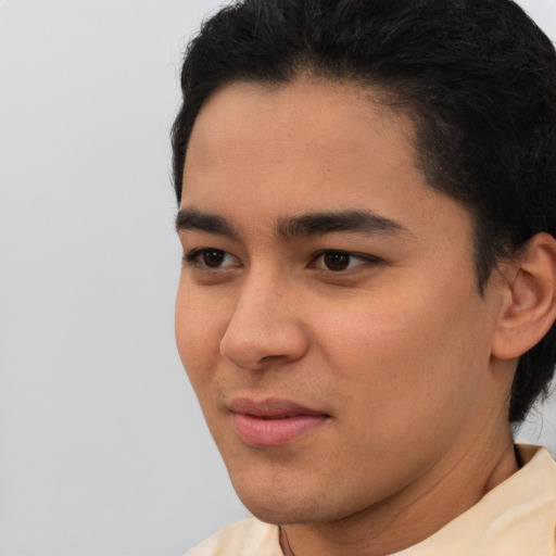 Joyful asian young-adult male with short  brown hair and brown eyes