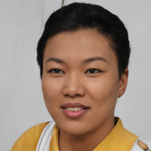 Joyful asian young-adult female with short  black hair and brown eyes