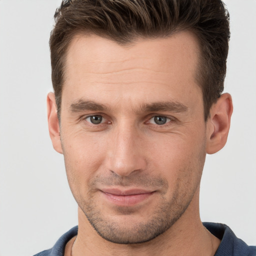 Joyful white young-adult male with short  brown hair and brown eyes