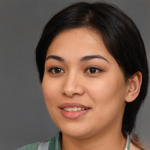 Joyful latino young-adult female with medium  brown hair and brown eyes