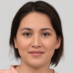 Joyful white young-adult female with medium  brown hair and brown eyes