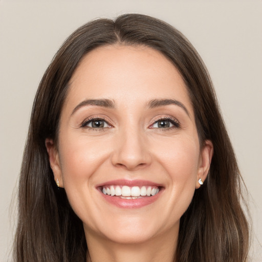 Joyful white young-adult female with long  brown hair and brown eyes