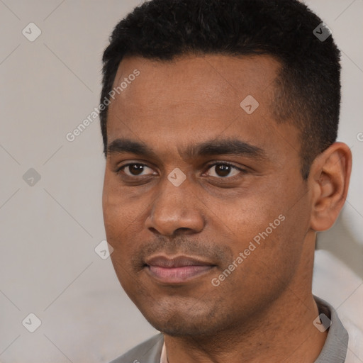 Joyful black young-adult male with short  black hair and brown eyes