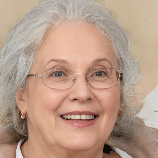 Joyful white middle-aged female with medium  gray hair and blue eyes