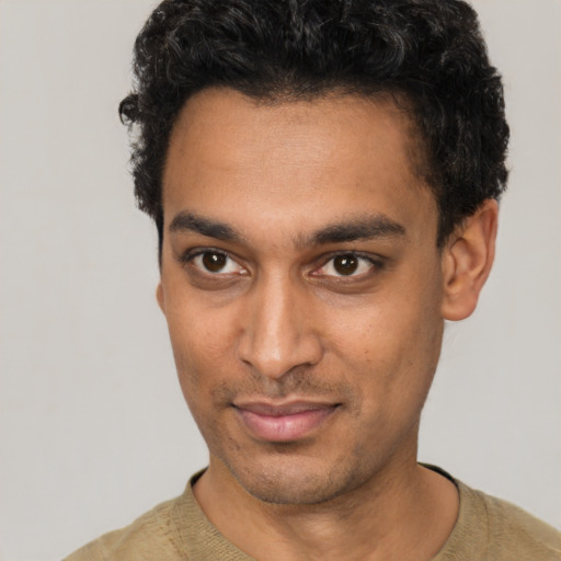 Joyful white young-adult male with short  black hair and brown eyes