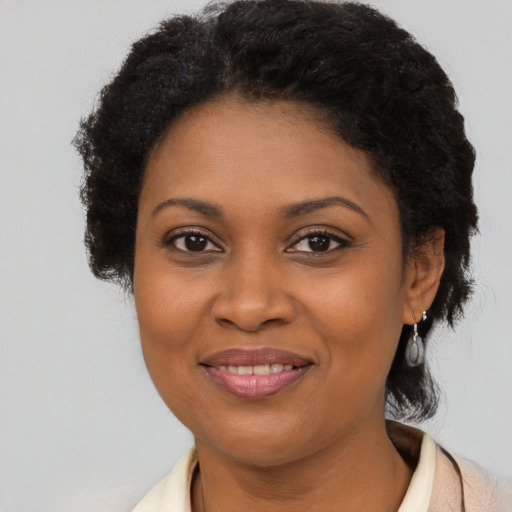 Joyful latino adult female with short  brown hair and brown eyes