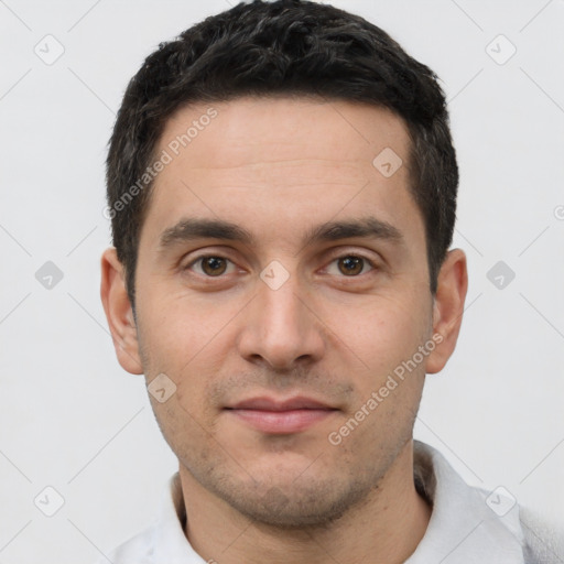 Joyful white young-adult male with short  black hair and brown eyes