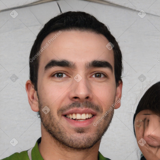 Joyful white young-adult male with short  black hair and brown eyes