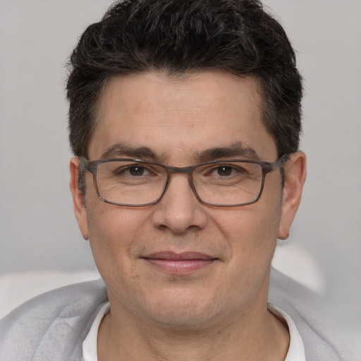 Joyful white adult male with short  brown hair and brown eyes