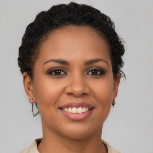 Joyful latino young-adult female with short  brown hair and brown eyes